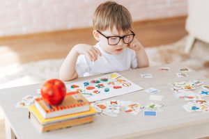 The child is studying at home, English learning with cards, educational games for children, teaching gifted children, children of genius